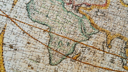 Dynamic view finished puzzle displaying vintage global chart. Jigsaw connected