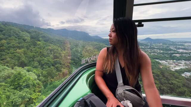 Asian Woman Rides Cable Car In The Wet Tropics World Heritage Area, Queensland, Australia