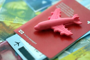 Swiss franc banknotes and passport with tickets. The current francs money bills and biometrical pass