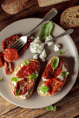 Ciabatta with sun dried tomatoes in olive oil, ricotta, and basil.