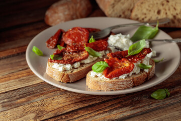 Ciabatta with sun dried tomatoes in olive oil, ricotta, and basil.