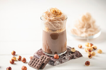 Chocolate pudding or panna cotta with nuts and cotton candy 