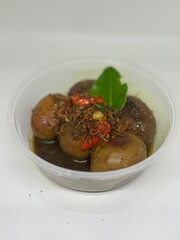 eggs in shrimp paste and soy sauce in a white bowl