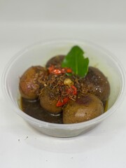 eggs in shrimp paste and soy sauce in a white bowl