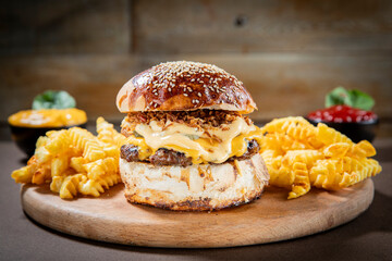 Cheddar Cheeseburger with Crispy Onions and Crinkle-Cut Fries on Rustic Wooden Board