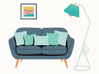 Blue sofa with colorful pillows and a floor lamp with abstract art on wall couch furniture