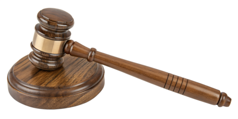 A wooden gavel and its matching circular sound block. The gavel, made of dark, polished wood, has a brass band around its head and a carved handle. It is resting diagonally on the sound block.