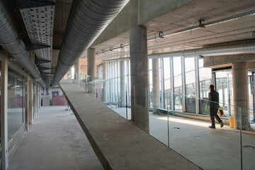 A captivating view of a modern business building under construction, showcasing its raw industrial...