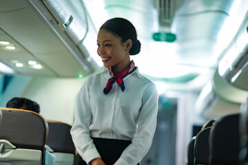 Bright and smiling airline staff member captured in candid style inside the cabin, representing...