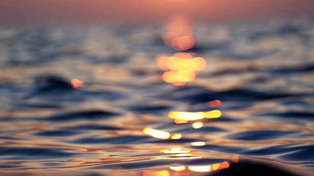 soothing 4k slow motion of soft ocean waves lapping at the shore under golden evening light with sparkling bokeh highlights creating a dreamy beach ambiance ideal for vacation and relaxation themes