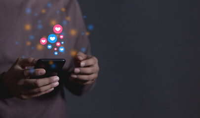 Love And Like Social Media Concept, Young Man hand using smart phone mobile, with Social Media, on soft blurred background
