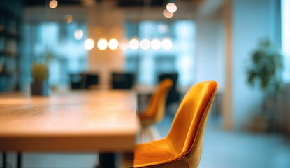 Blurred modern office space, light wood table, mustard chairs