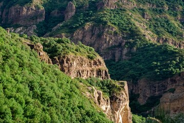 Lush green cliffs and rugged mountains in a serene natural landscape