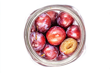 Obraz premium a jar of plums with a piece of a peanut in it