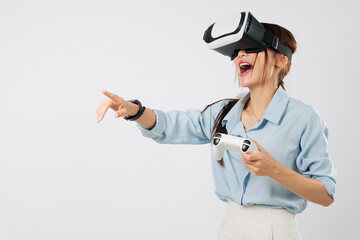 VR game scene of Young woman in headset pointing on screen during VR game play with controller in...
