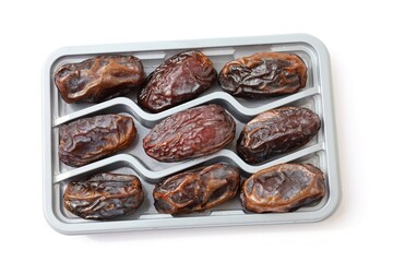 Big Dates Isolated. Date Palm Fruits. Big dates in a plastic container isolated. Dry date fruits, medjool, medjoul or majhool packaging, royal dates on white background top view