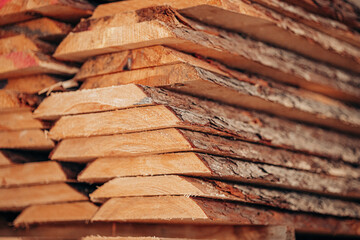 Rough-Cut Timber Planks Stacked with Bark Edges