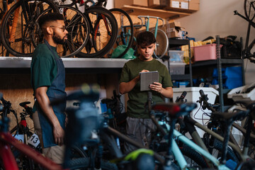 Bicycle mechanics managing inventory in repair shop