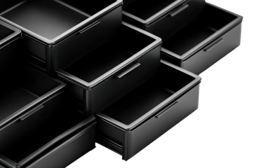 Close-up view of multiple, stacked, black storage drawers.  Organized, geometrically, with visible drawer handles.  Dark background