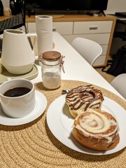 Cinnamon rolls with coffee and sugar on a table, a sweet breakfast treat