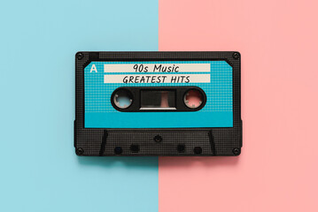Top view of vintage audio cassette tape with the text 90s music greatest hits. Retro music concept