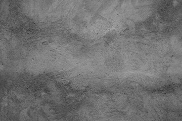 This is a grayscale image showing a textured surface that resembles a concrete wall or a similar...