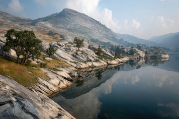 Mountain lake reflecting a hazy sky