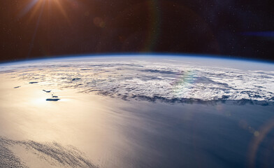 Earth in space. The surface of the planet Earth and the sun's rays reflecting off the ocean. View from space of Atlantic Ocean and the coast of Africa.