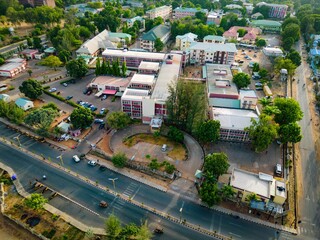 Barau Dikko Hospital, Nigeria - 15 March 2025: Aerial view of the Barau Dikko Hospital, a complex of buildings and roads, painted in contrasting shades, under a vast sky.