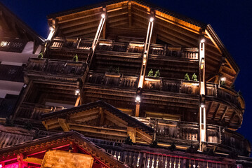 Illuminated Wooden Chalet at Night in French Alpine Resort
