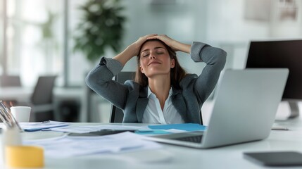 Exhausted businesswoman taking a moment to rest at her desk after a long and stressful workday