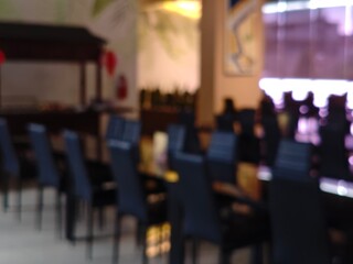 Abstract Interior Blurred Restaurant Scene with Tables and Chairs Soft Lighting.