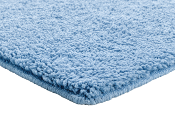 Close-up of a light, periwinkle blue bath mat with a textured pile.  The corner is visible, showing a subtly scalloped edge