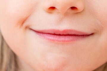 Close-up portrait five year old preschool girl with gentle smile, Childhood happiness, innocent and heartwarming smile, emotional development and empathy skills, Social-emotional learning