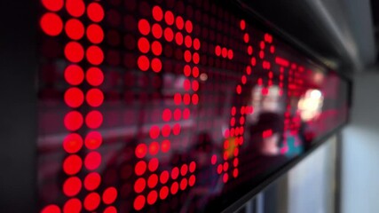 Red LED digital display showing time 13:40 with bright dot matrix numbers, symbolizing punctuality, public information, and real-time schedules for travel or events - Powered by Adobe