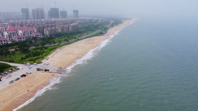 Tilt up shot of Nanhai beach and cityscape view, China