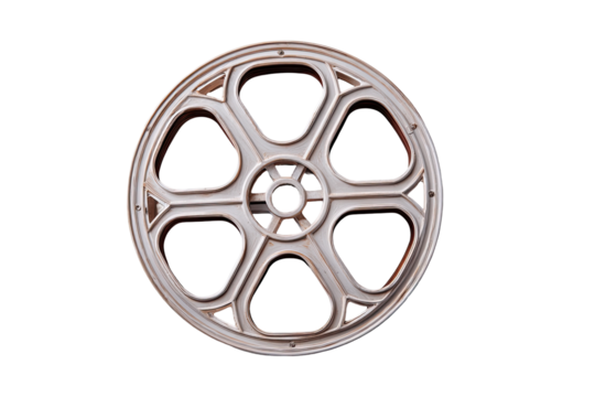 Vintage film reel.  A light beige or cream-colored film reel, circular, with a segmented design.  Each segment is arched with decorative details.  Isolated on black background