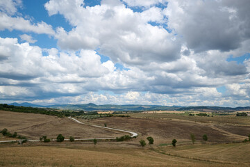 Obraz premium landscape of tuscany with blue sky with clouds and hills and trees