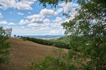 Obraz premium landscape of tuscany with blue sky with clouds and hills and trees