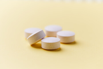 Creatine tablets on paper background. Soft focus. Close up. Copy space