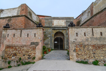 Fototapeta premium Symmetrical Gate of Fort Stella Flanked by Cannonball-Topped Bastions, Elba, Italy
