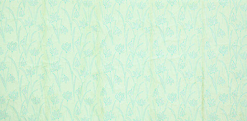 Old wallpaper on the wall. Old wallpaper for texture or background.