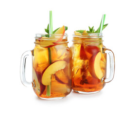 Refreshing iced peach tea with mint in mason jars isolated on white
