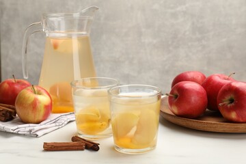 Tasty compot with apples and cinnamon on white table