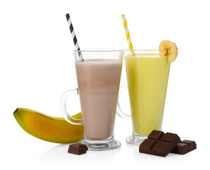 Different tasty milkshakes in glasses and ingredients isolated on white
