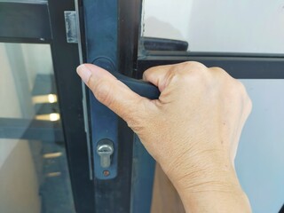 hand opening a door handle