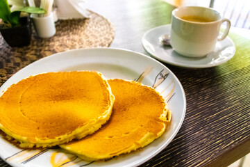 Cup of coffee and Russian pancakes in restaurant in Belarus.