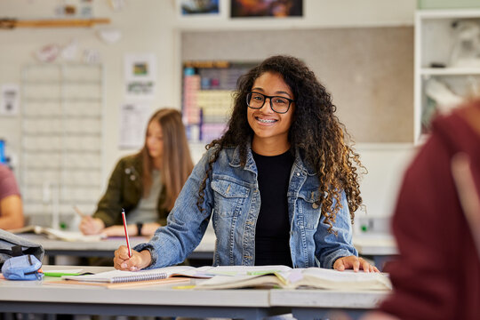 Smiling african american student in classroom looking at camera