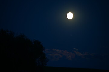 Waxing August Full Moon Over the Horizon – Dark Night Sky