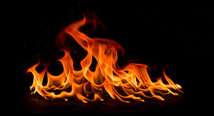 Fiery flames dancing against a dark background.